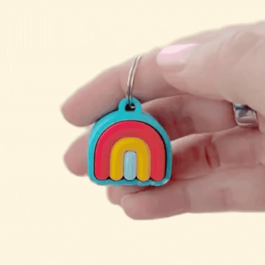 Portable two-mode fidget: click to stim or glide a thumb over soft curves.