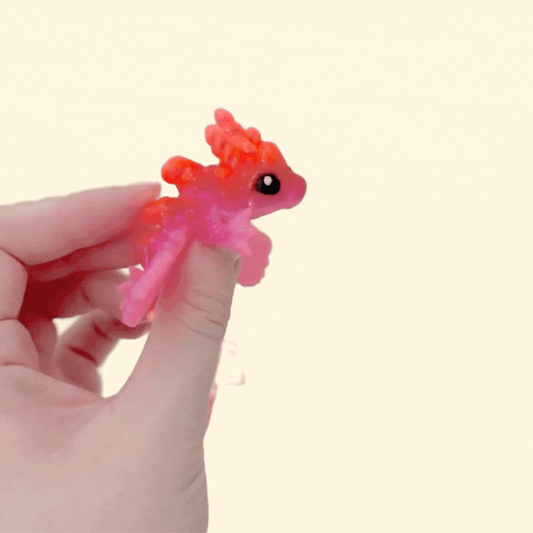 Flexible dragon toy with segmented body, movable wings, and tactile articulated joints.