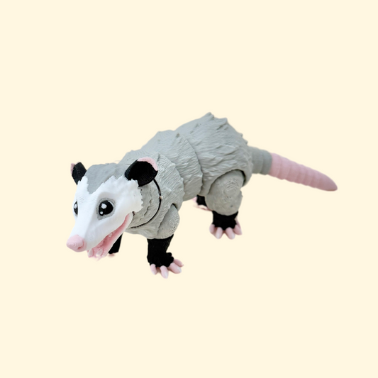 Close-up of the possum fidget toy showcasing its fully articulated movement, including a ball-jointed head and opening mouth.