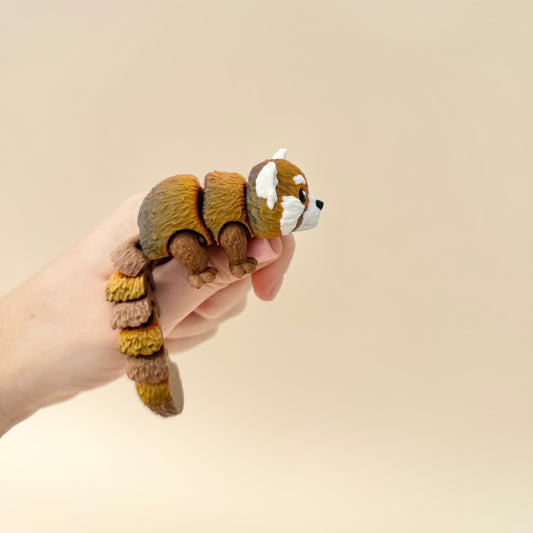 Fully articulated red panda sensory toy with moveable tail, legs, and body, perfect for fidgeting.
