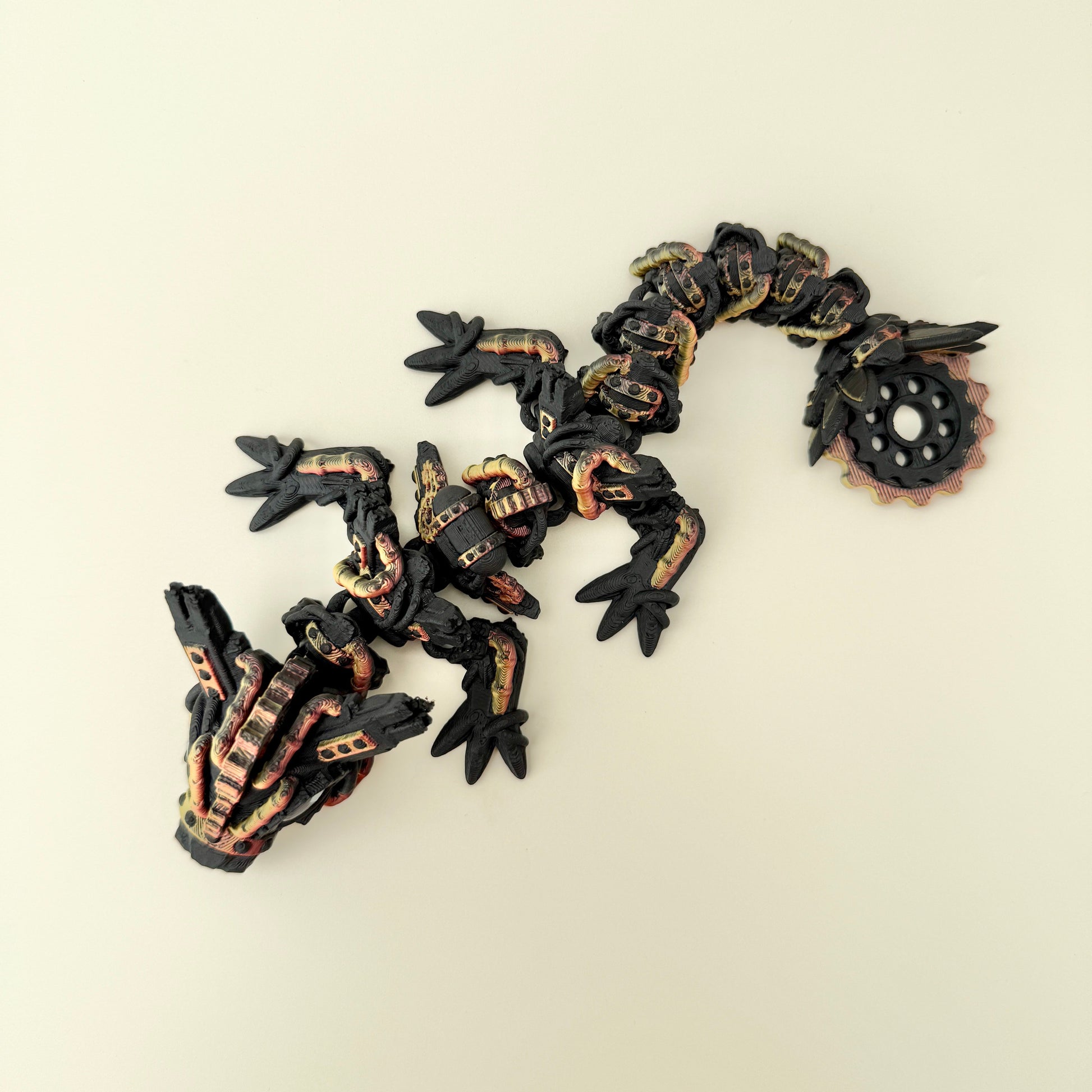 Large flexible dragon fidget toy with textured gear-style details and raised surfaces for tactile sensory play