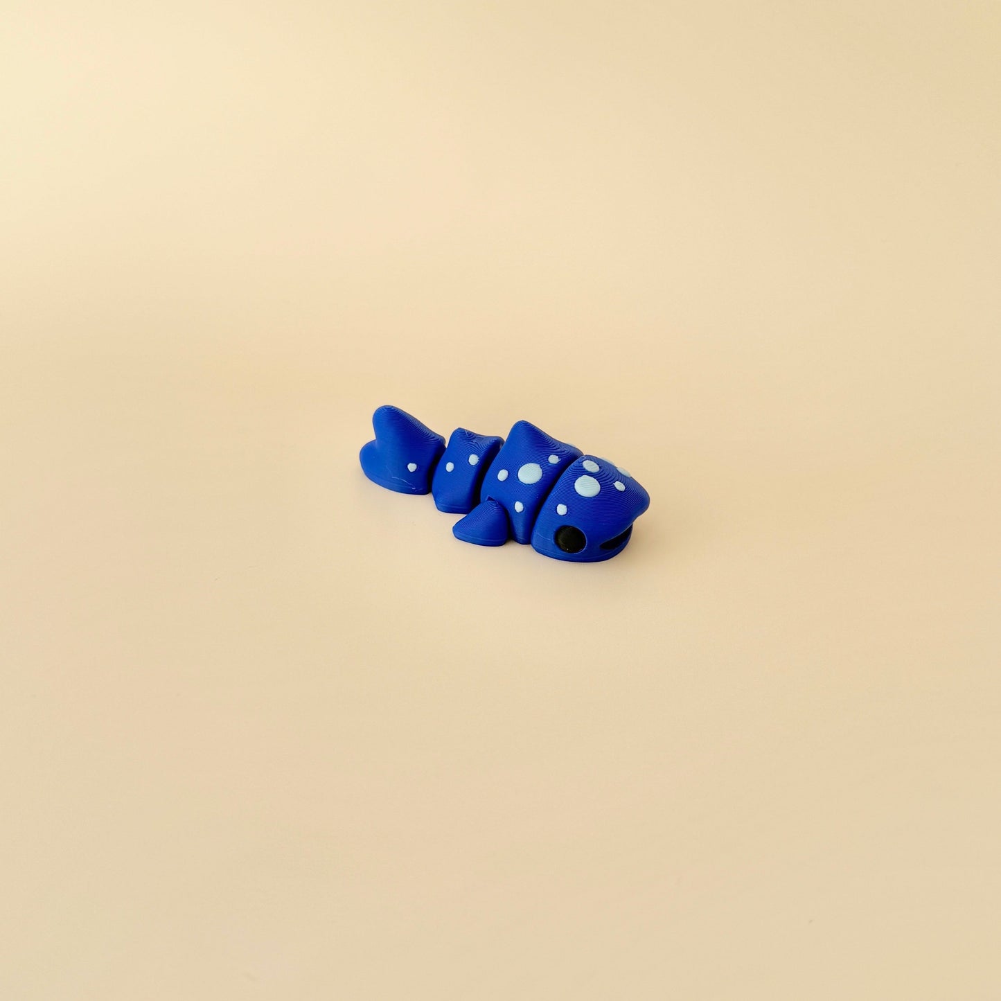 Marine-inspired fidget toy shaped like a whale shark, featuring a moveable body for tactile play.