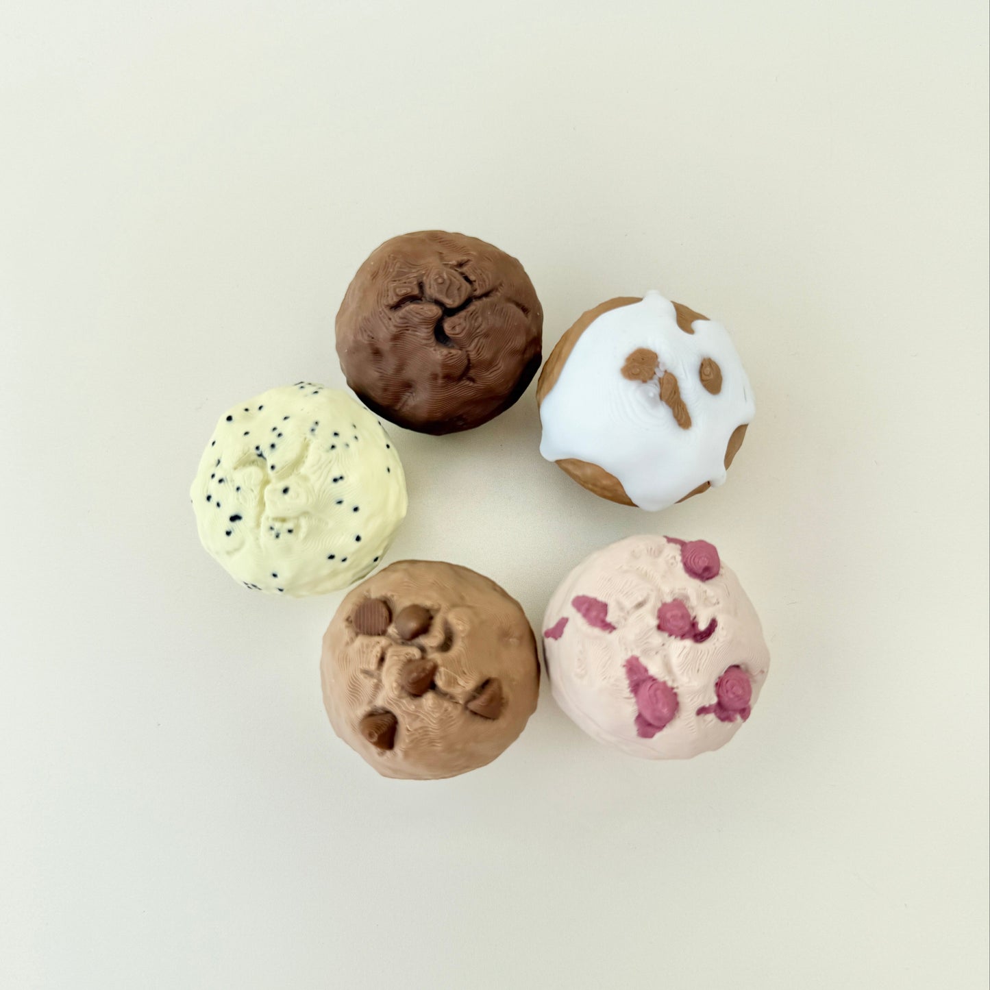 Small muffin-shaped fidget with a clickable centre and realistic dessert-style textures for sensory play.