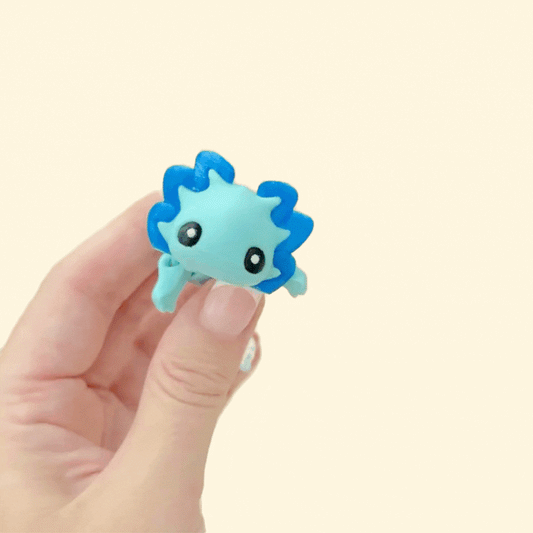 Fully articulated dragon fidget in light and dark blue tones, designed for finger movement and sensory play.