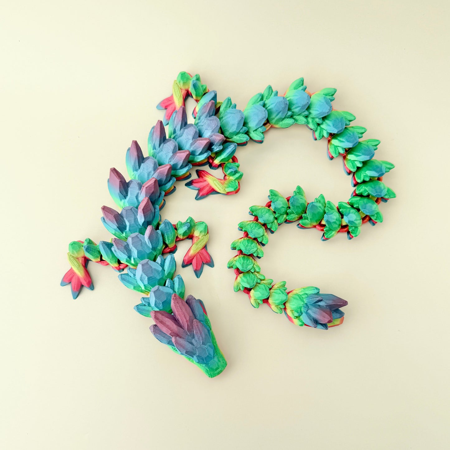 Fully articulated rainbow sensory dragon toy with detailed limbs and tail