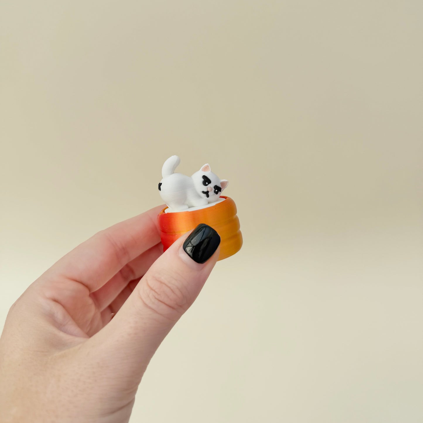 Humorous cat clicker; sturdy 3D-print, clicky feedback, calming hand fidget for neurodivergent users and collectors.