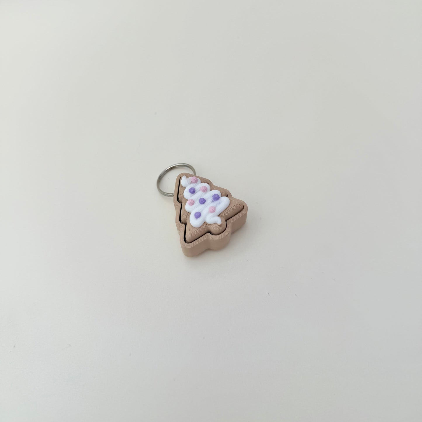 Cute seasonal fidget with tactile finish and compact size; upgrade available to quiet click.