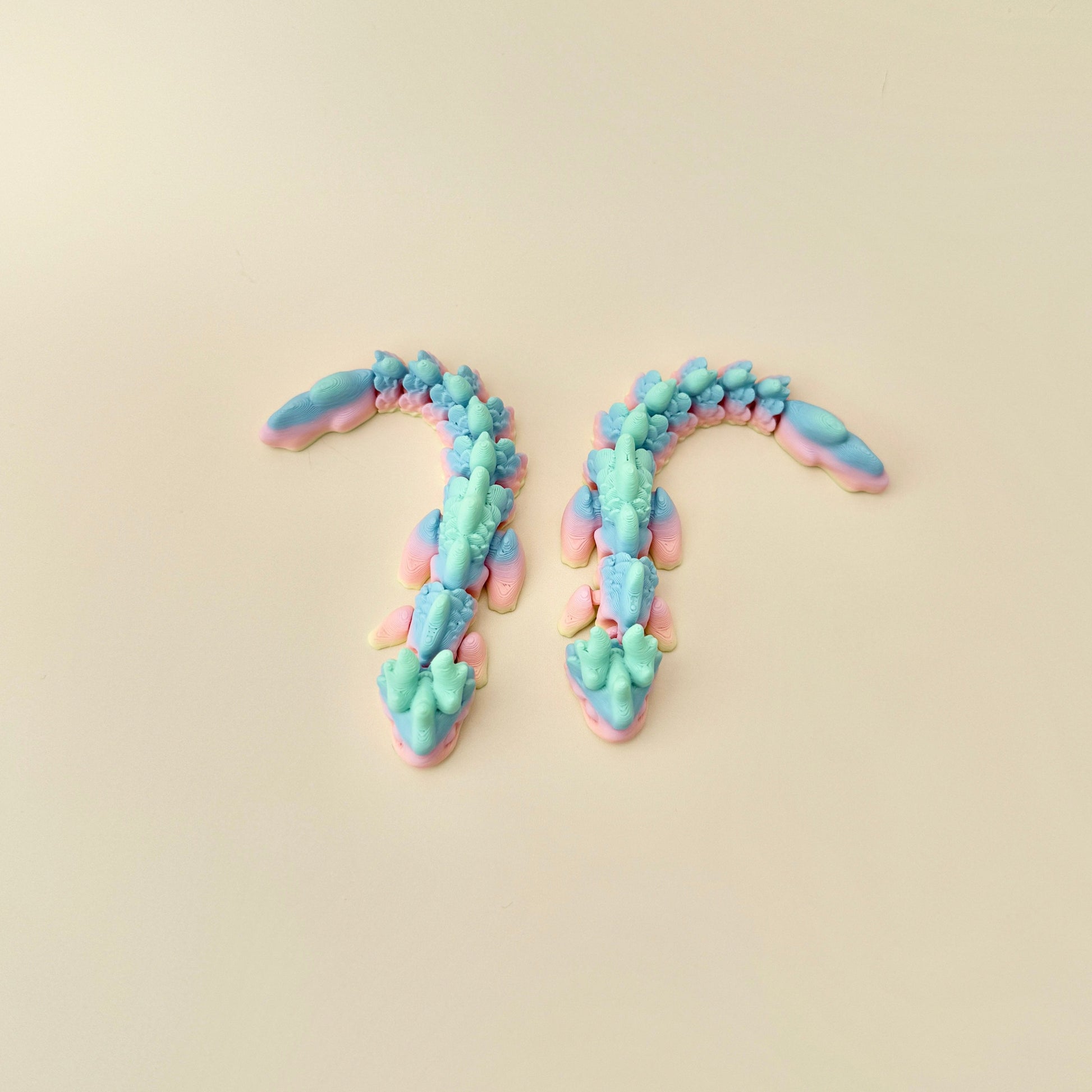 Mini Rainbow Dragon featuring a smooth rainbow gradient finish and black eyes, perfect for fidgeting or displaying.