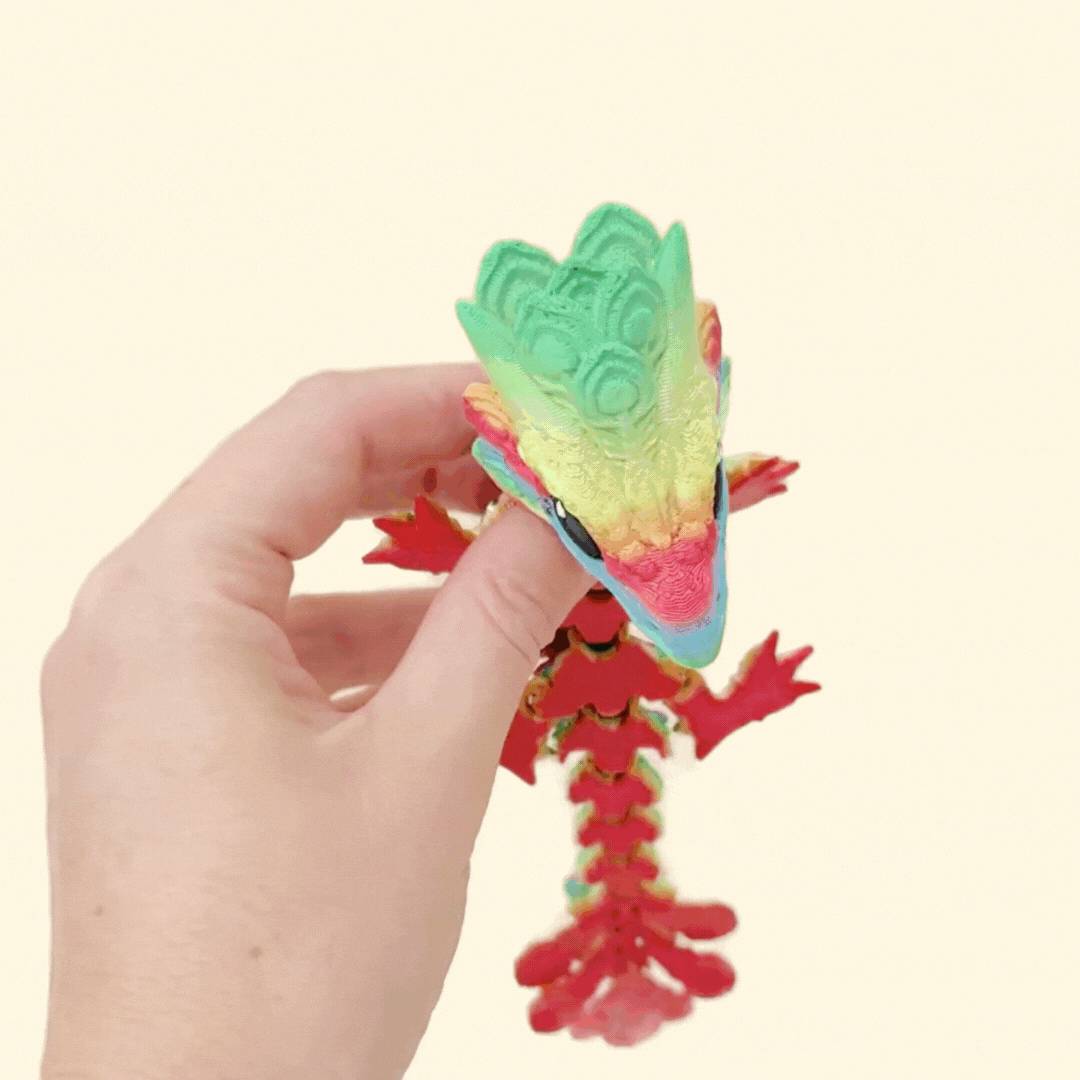 collectable articulated dragon fidget in a rainbow colourway with tactile textures, designed for neurodivergent users and dragon fans