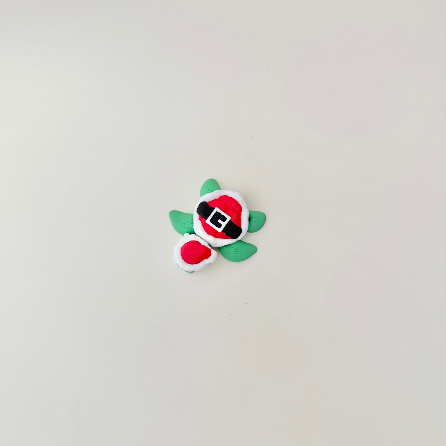 Limited run turtle in red, white and green for people who collect our seasonal fidgets.