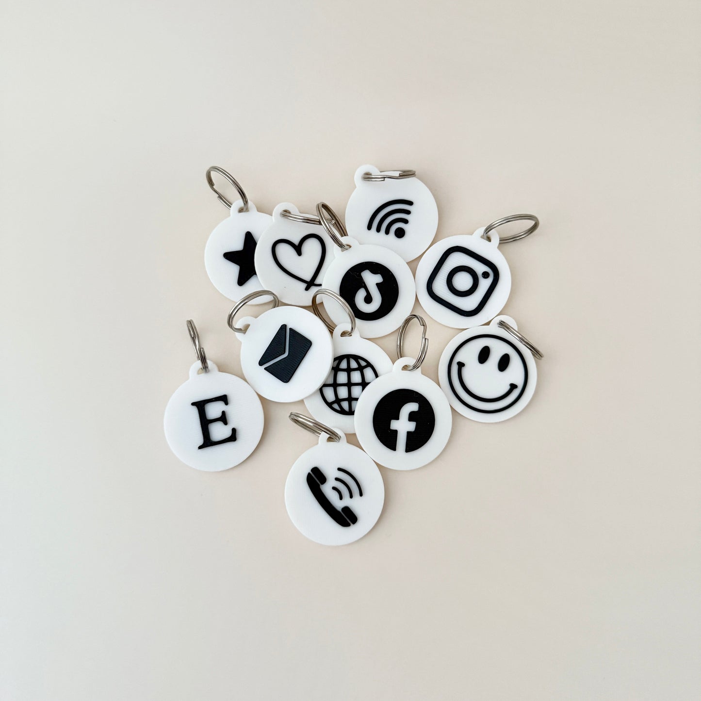 Compact NFC keyrings shown next to a coin for size comparison, emphasising their portability and practicality.