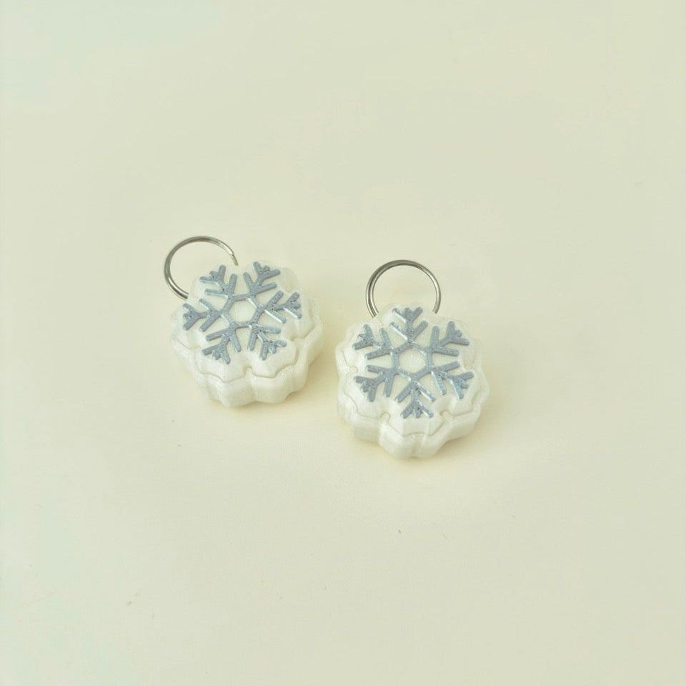 palm-size winter fidget, raised snowflake top and satisfying press