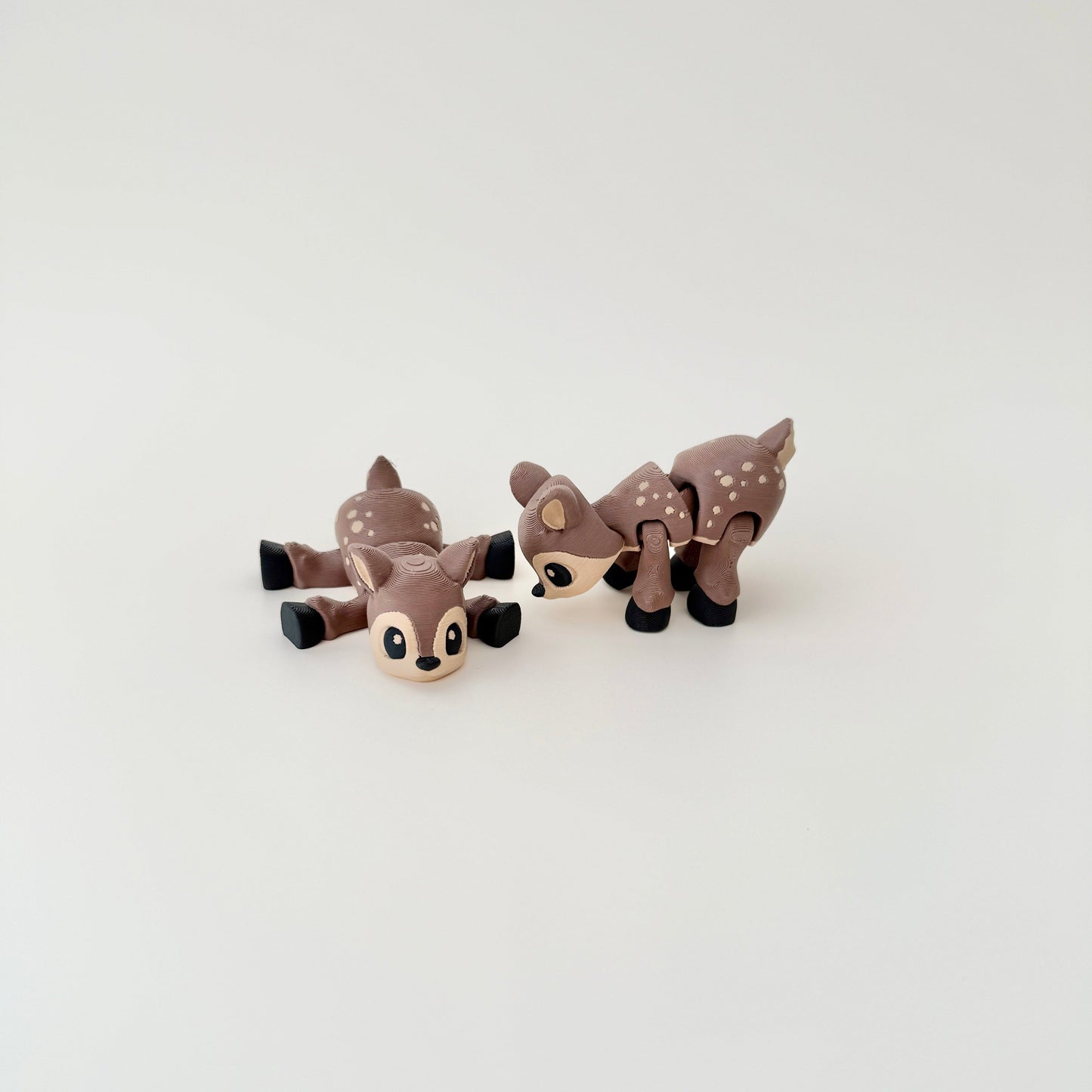 Deer fidget toy shown lying flat, showcasing its detailed body and flexible design.