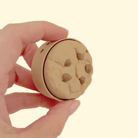 Compact cookie-style clicker fidget suitable for one-hand use at desks or workspaces.