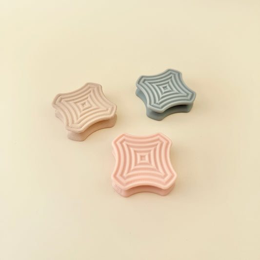 SnapSquares fidget toy available in discreet and calming colours, including dark rainbow, nude, grey, and peach. Perfect for work, school, or everyday fidgeting.