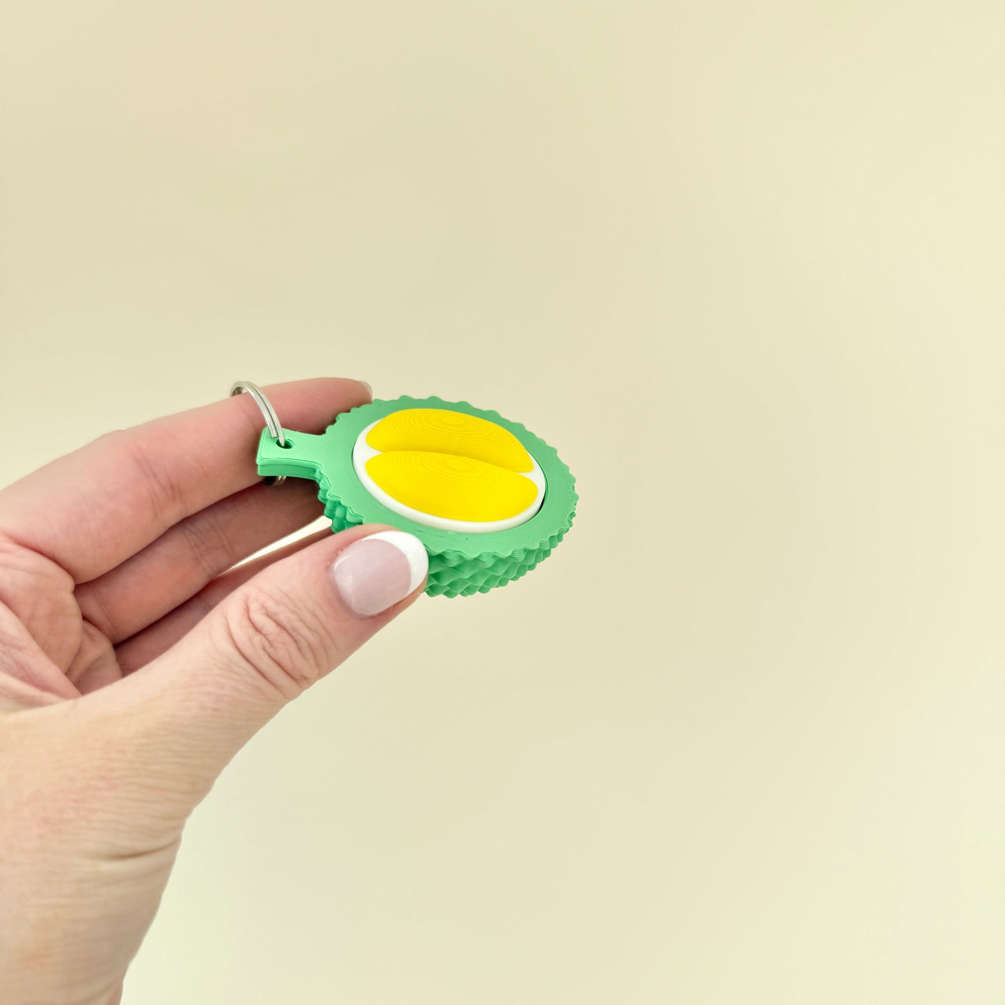 Durable tactile fidget clicker featuring durian fruit styling and keyring