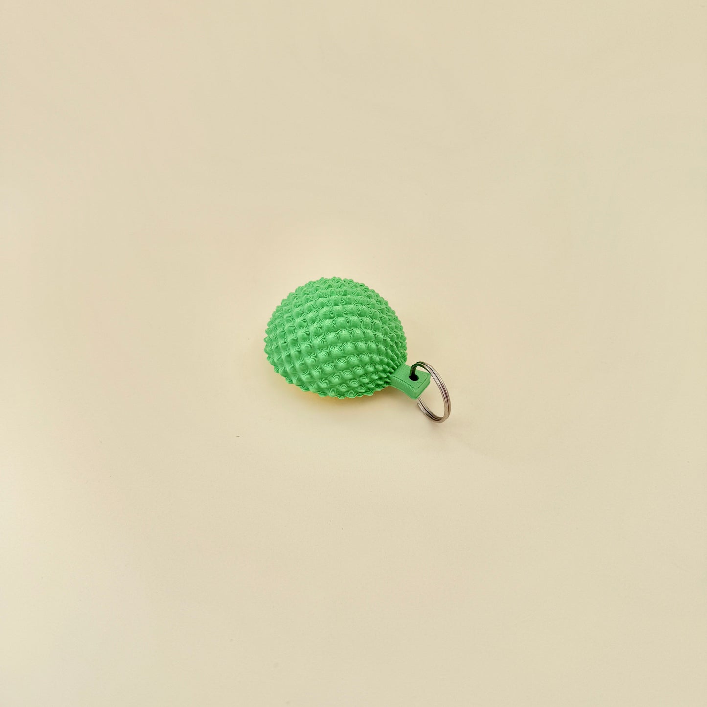 Portable fidget clicker toy modelled after a durian fruit