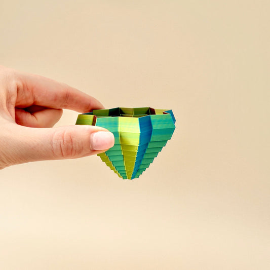 ShapeShifters Star toy shown with cascading layers, showcasing its dynamic movement. Sensory star design