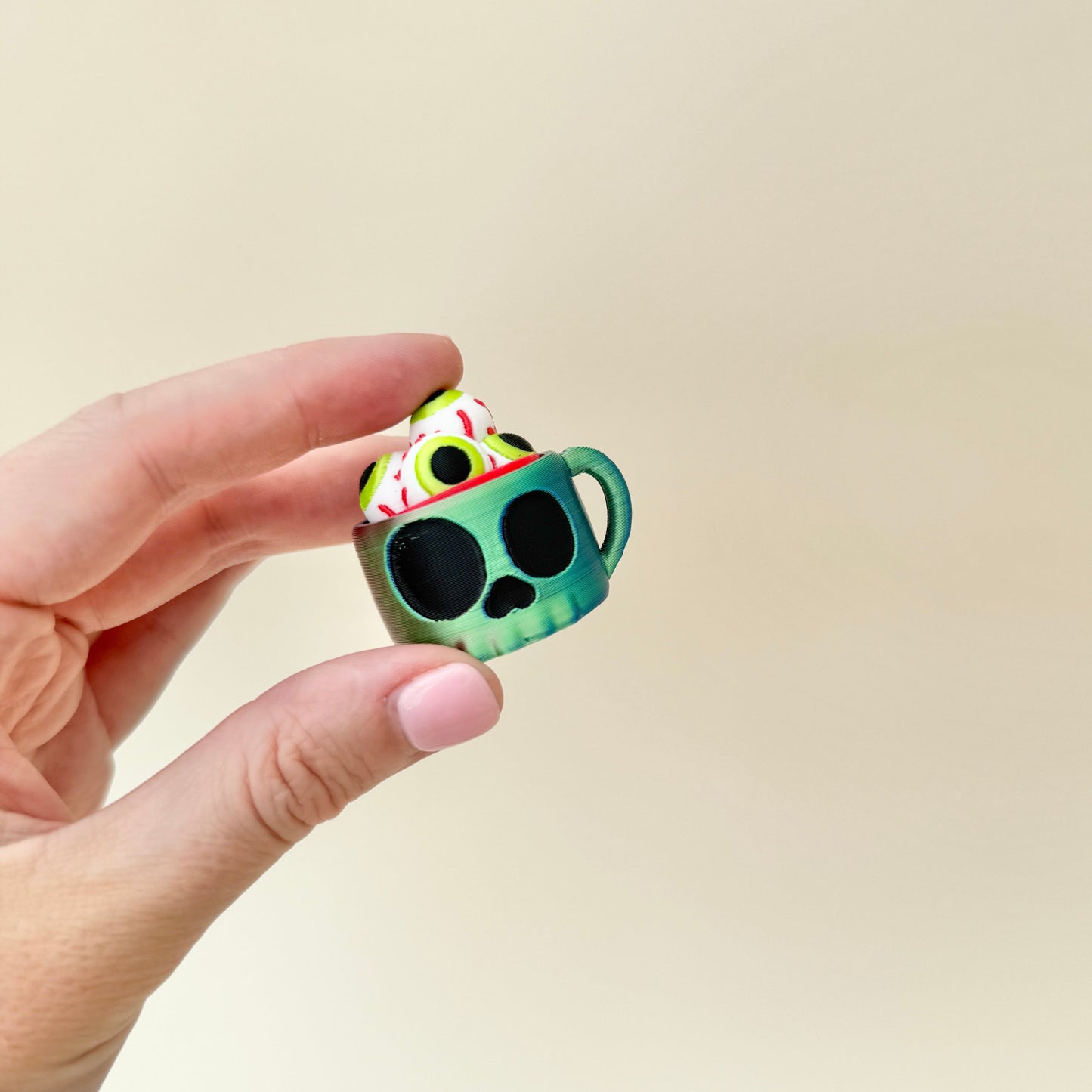 compact cup-shaped clicker fidget with tactile eyeball press