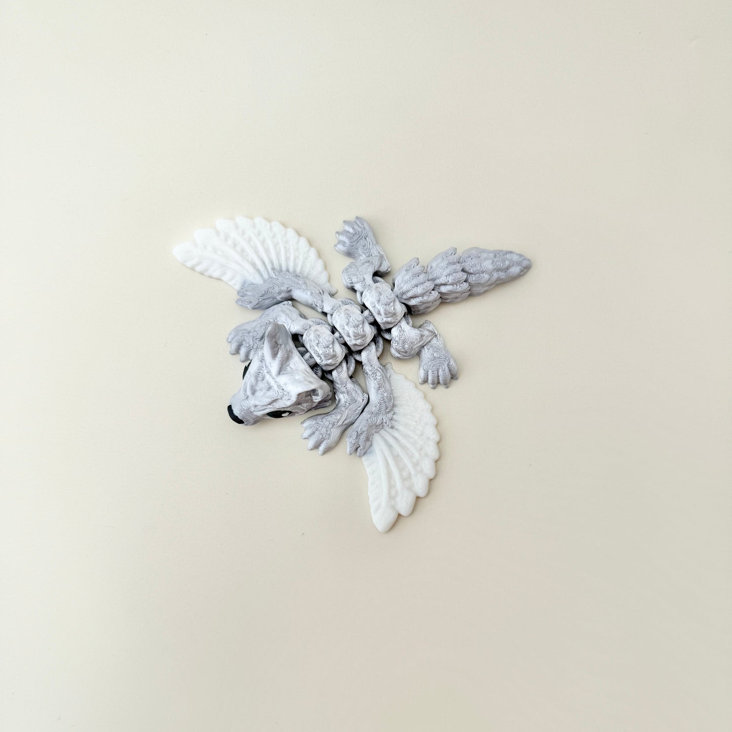compact articulated creature with wings and tactile details for sensory play
