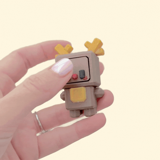 Chunky cube-style Christmas clicker with pressable face and raised textures; portable sensory fidget.