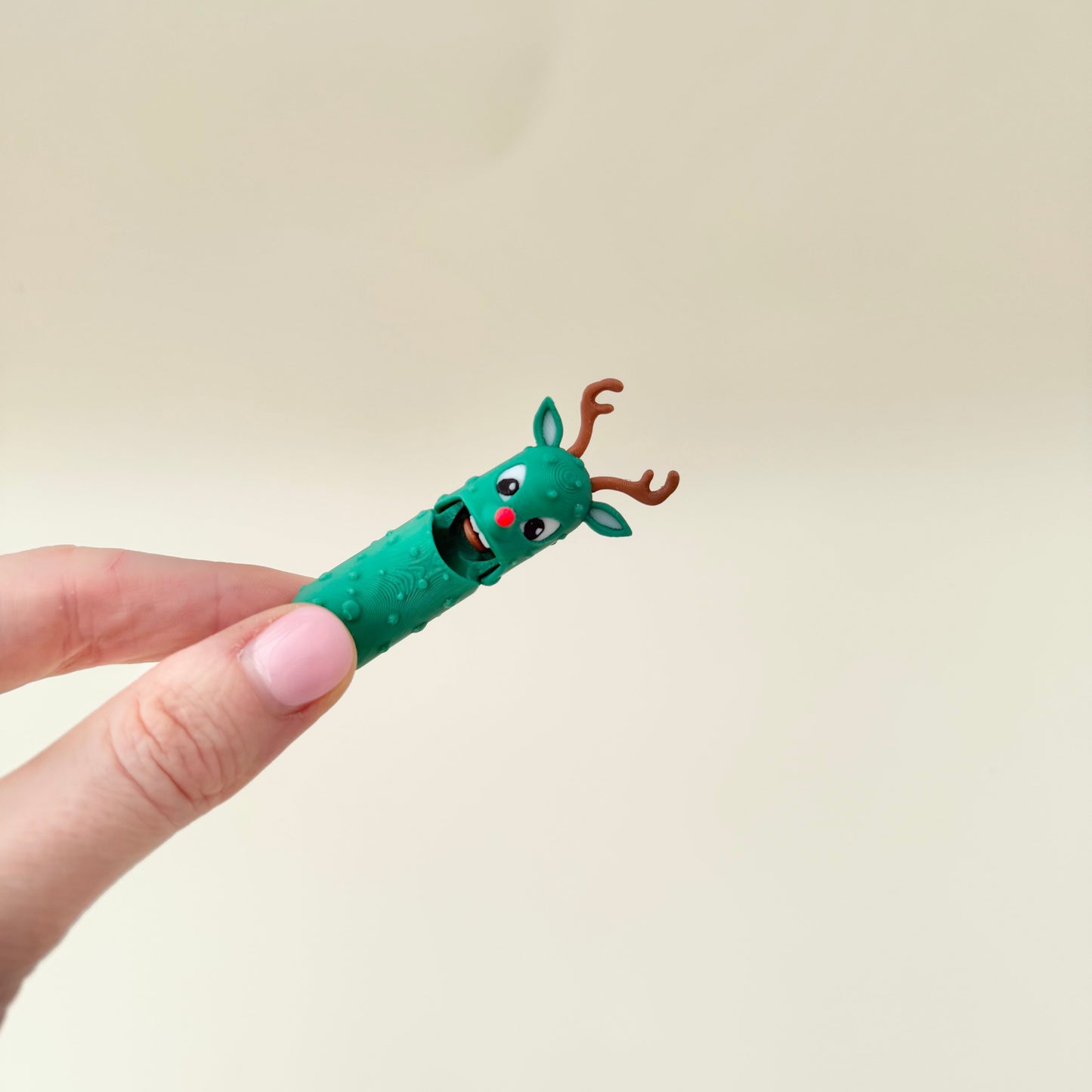 A Christmas-inspired pickle toy with raised textures and expressive details for sensory engagement.