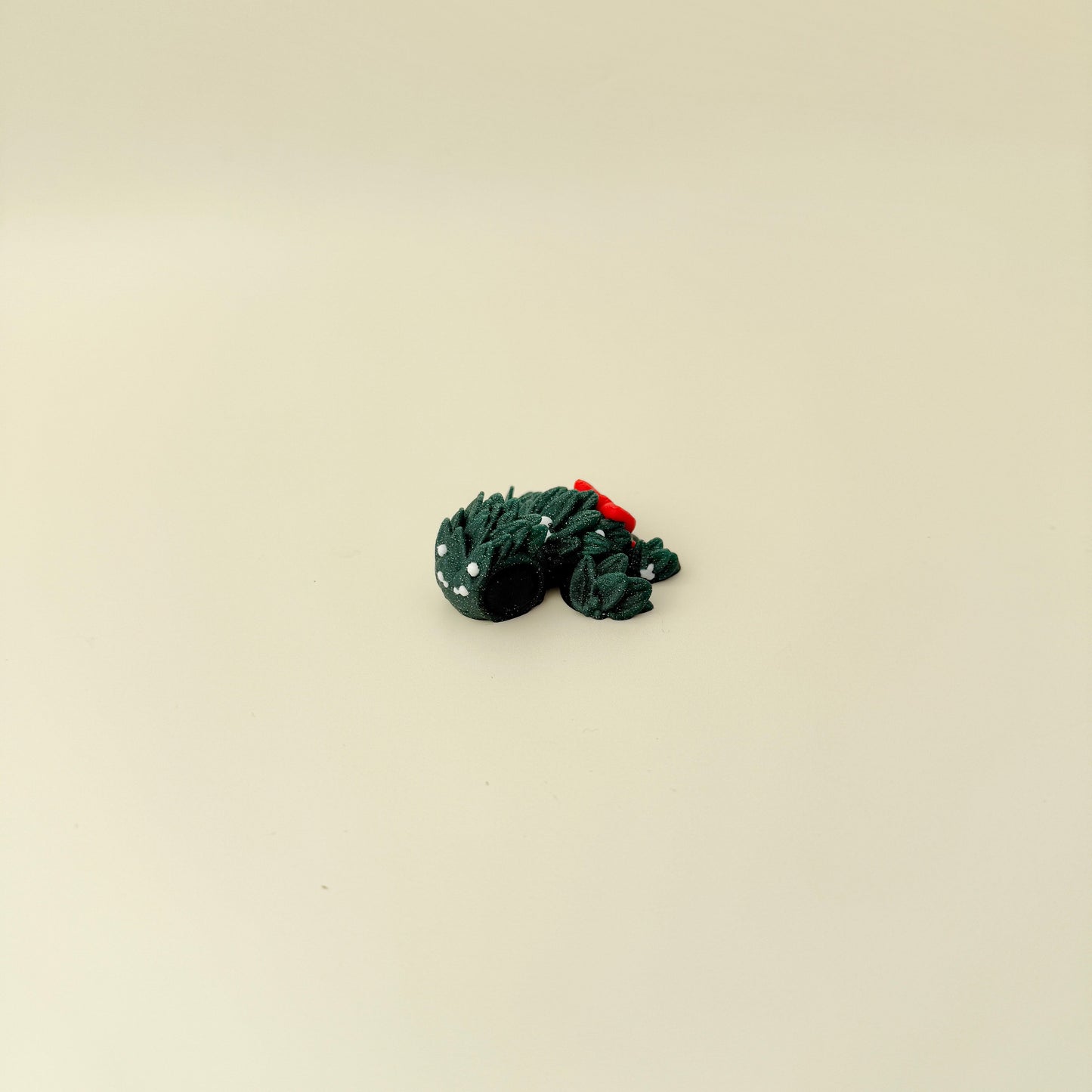 Mini turtle in sparkling evergreen with subtle white berry accents and smooth-to-ridgey tactile surfaces.