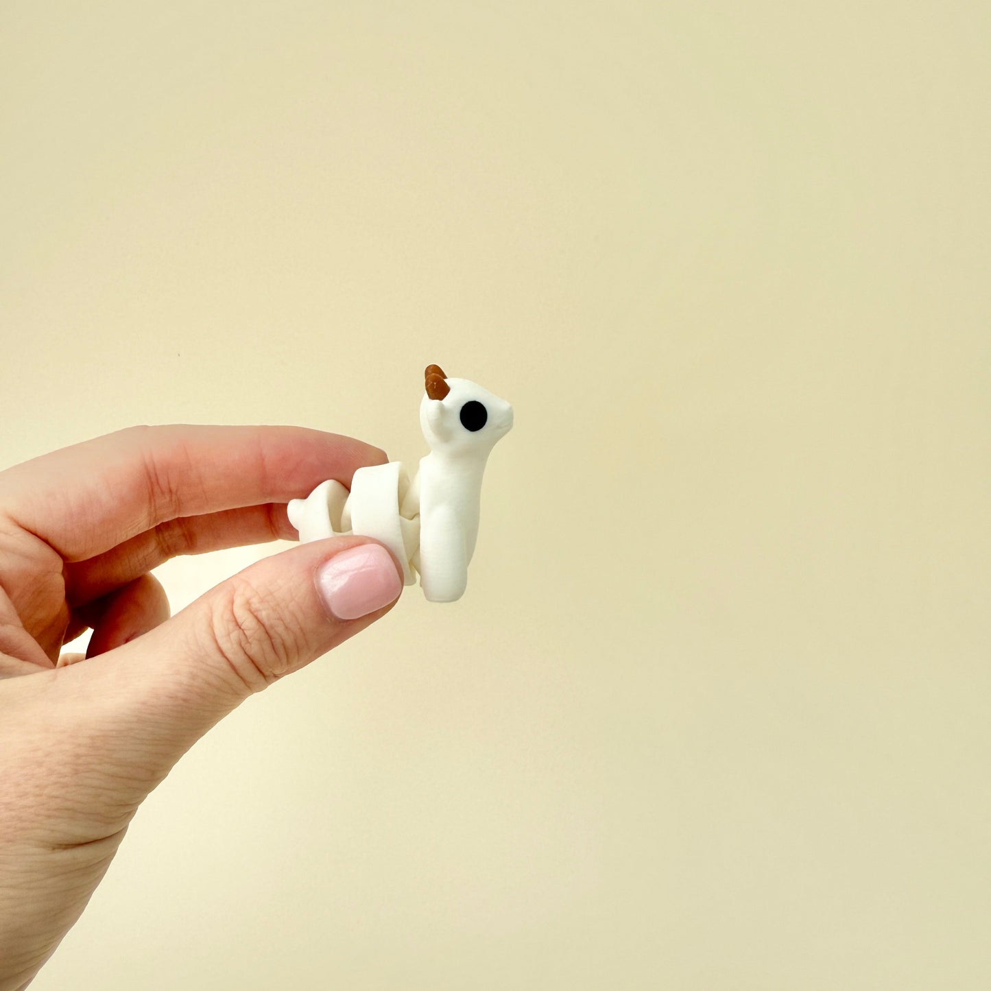 A three-piece articulated goat toy that moves smoothly for satisfying tactile play.
