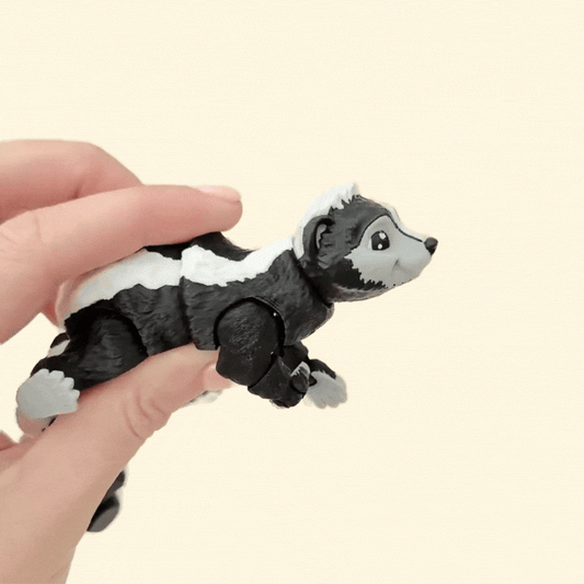 A sensory-friendly skunk fidget toy featuring a flexible tail, rotating head, and adjustable limbs for interactive play.