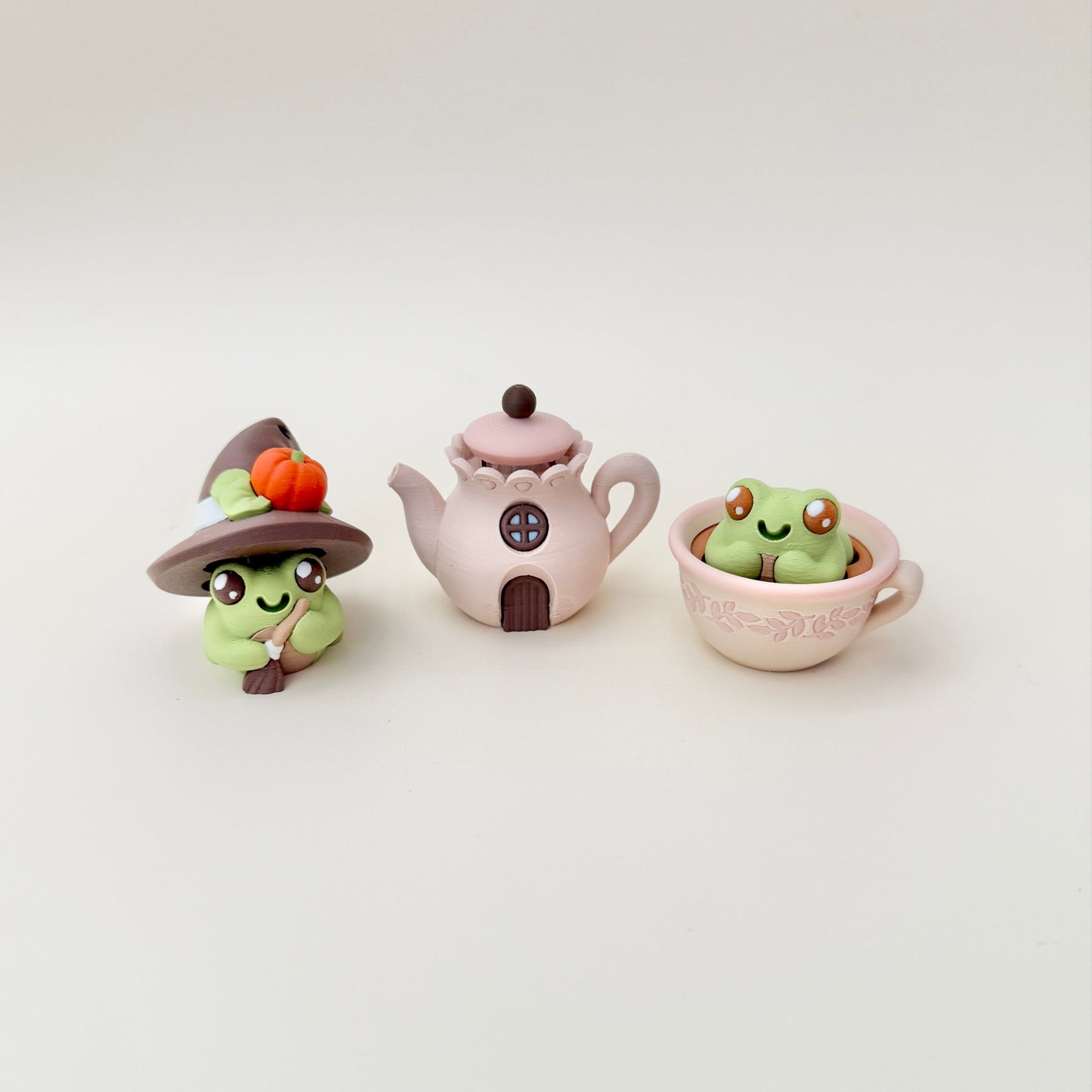 Teacup frog clicker that pairs with other frog and cottage pieces in the collection.