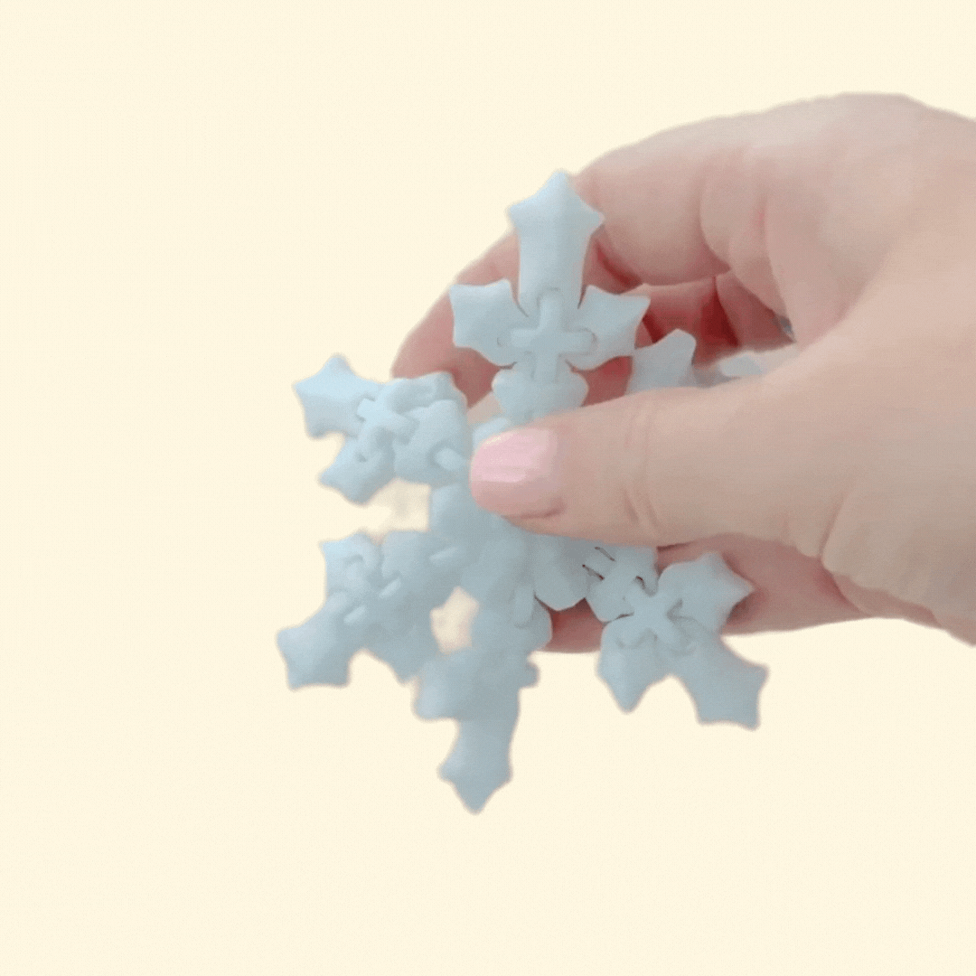 Flexible ornament-style fidget with a blue–white gradient; approx 10 cm and hang-ready.