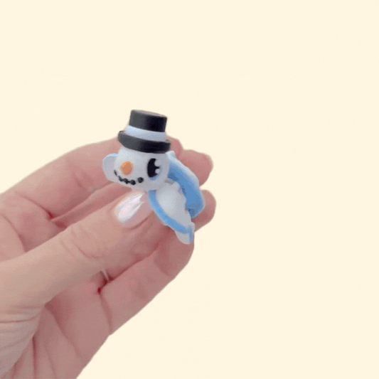 Portable articulated turtle fidget with winter theme; smooth and raised textures for soothing stims and pocket carry.