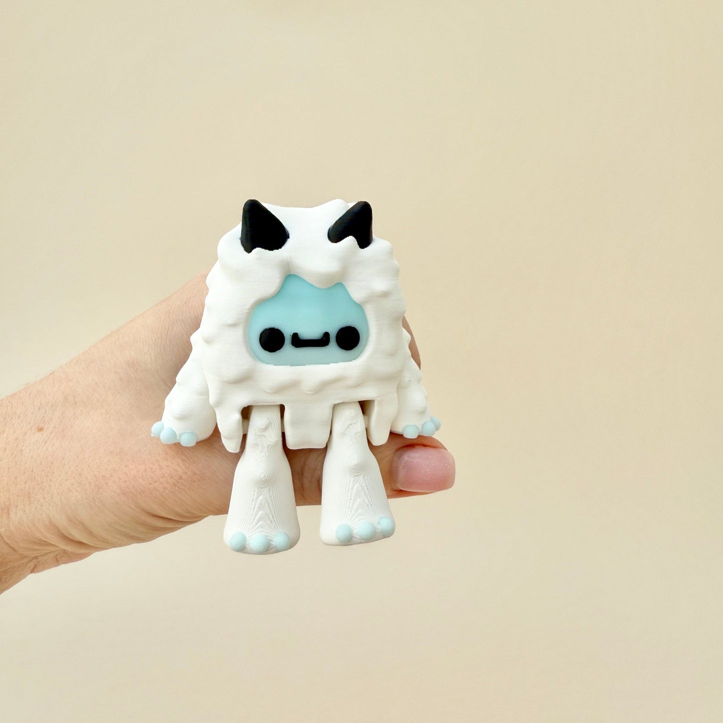 Frosted blue and white Yeti fidget toy with black horns, eyes, and claws, perfect for sensory play and display.