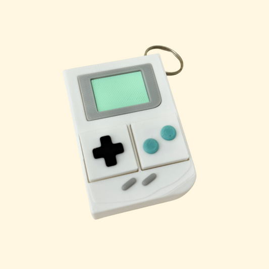 Pale-toned fidget with two clickable sections and attached keyring.