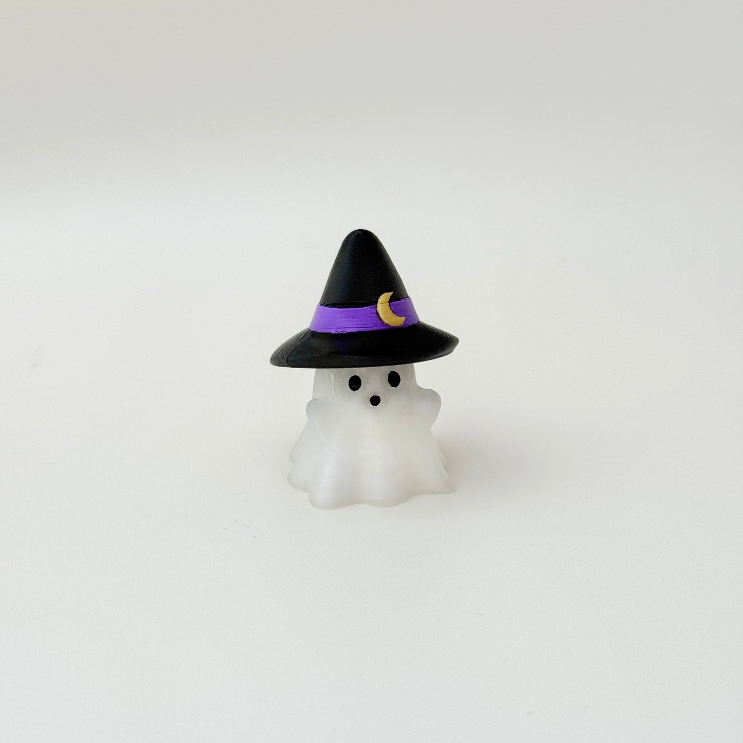 Mini ghost figure with a purple-banded hat and subtle tactile ridges for gentle fidgeting.