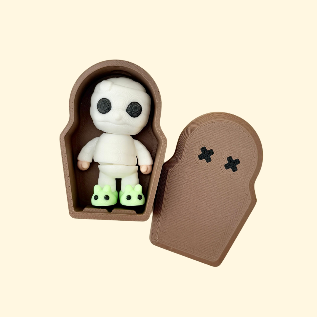 mini mummy figurine with glow slippers and a small coffin case for quiet sensory play