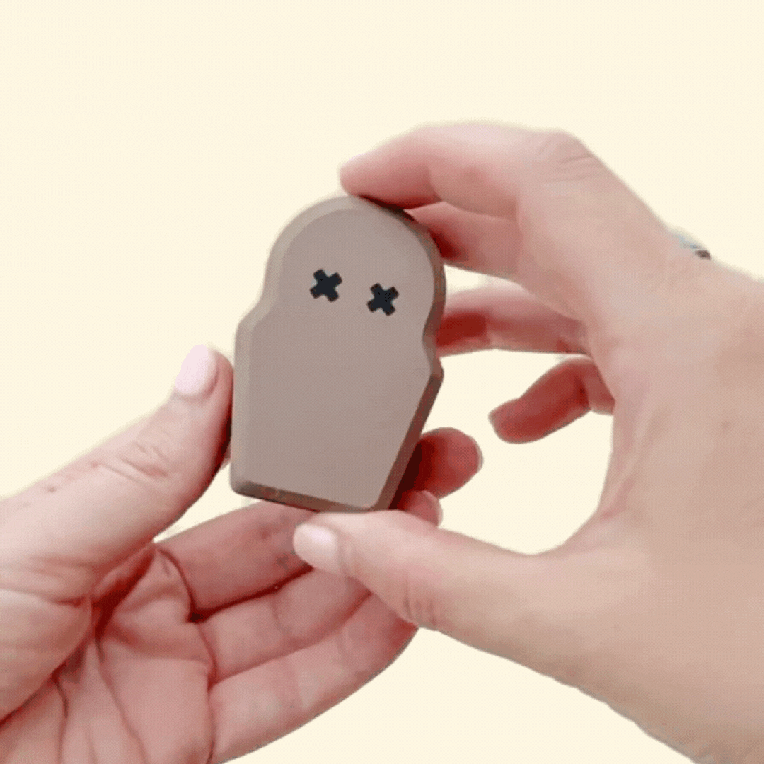 compact collectable with raised textures and gentle visual glow for grounding