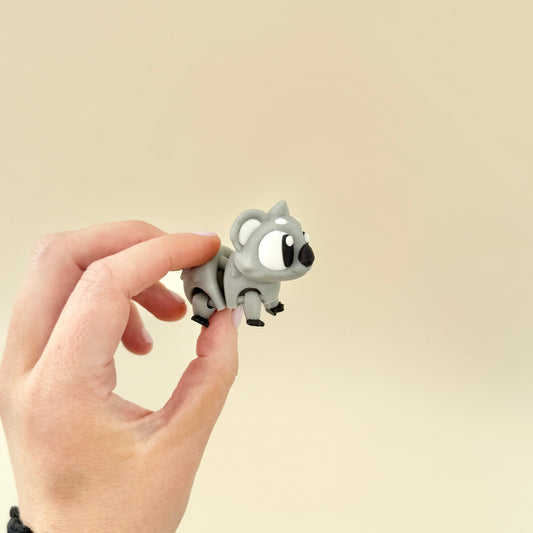 Cute and calming koala sensory toy with movable limbs and ball-jointed head for stress relief and sensory engagement.