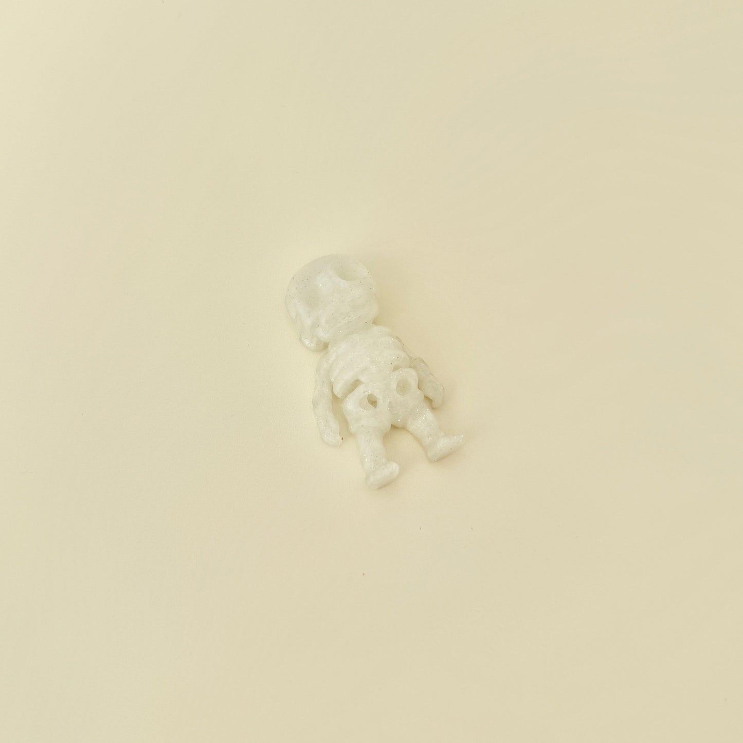 Small skeleton fidget with movable joints and sparkly frosted finish