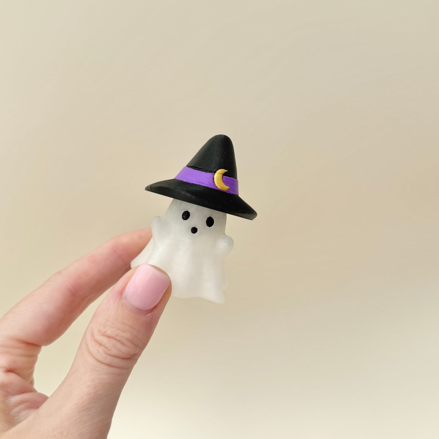 Compact ghost charm designed to clip onto keys, bags, or lanyards.