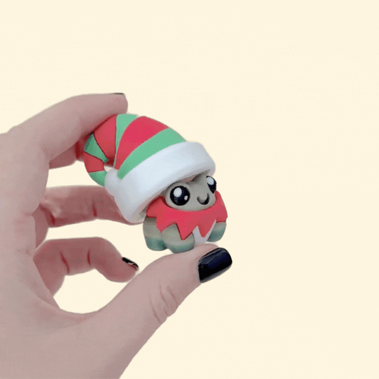 Cheerful Christmas frog clicker for focus and stimming; chunky build; smooth press; tactile edges.