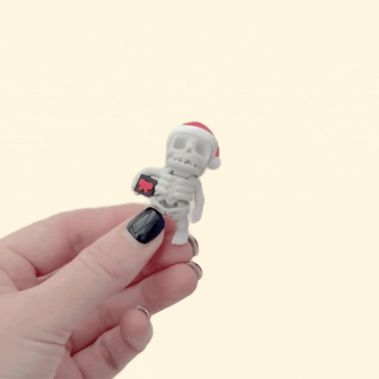 Mini poseable skeleton toy for festive sensory play.