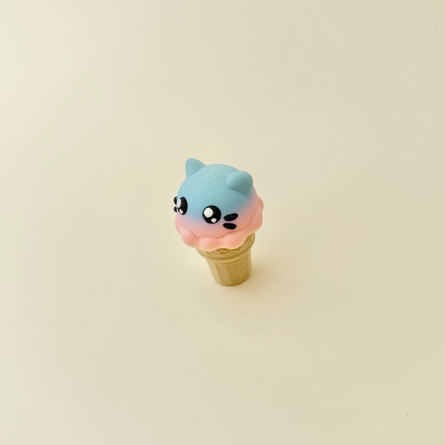 Novelty fidget toy shaped like an ice cream cone with cat features, perfect for sensory play