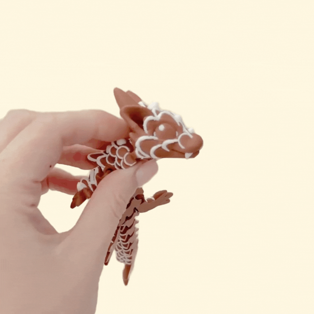 Poseable festive dragon with raised icing accents for tactile stimming.