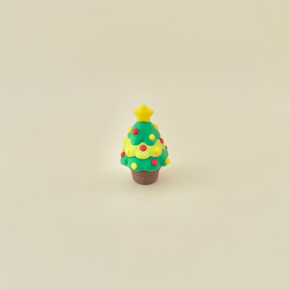 Textured baubles for thumb tracing; low-noise click action; palm-size festive desk fidget.