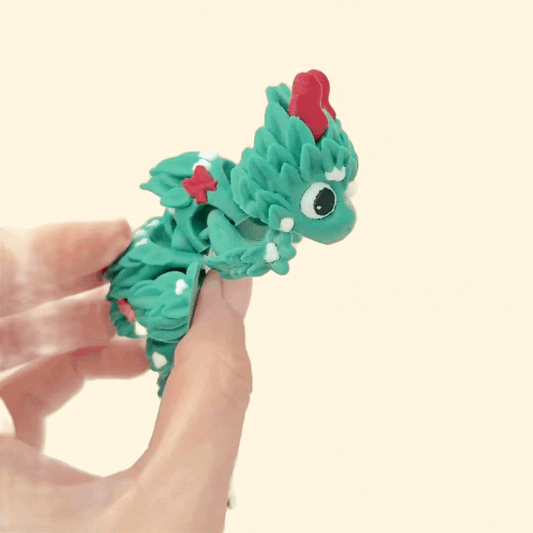 Festive dragon with a bright red tail bow and snowy accents.