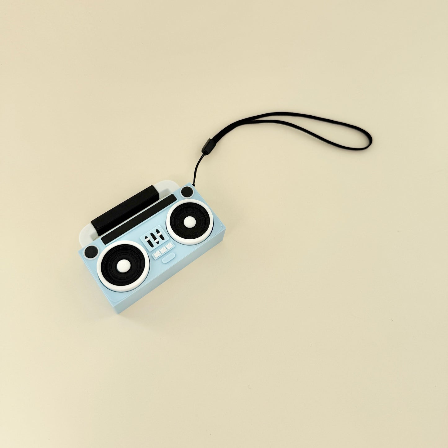 Handheld clicker with a nostalgic design and secure wrist strap