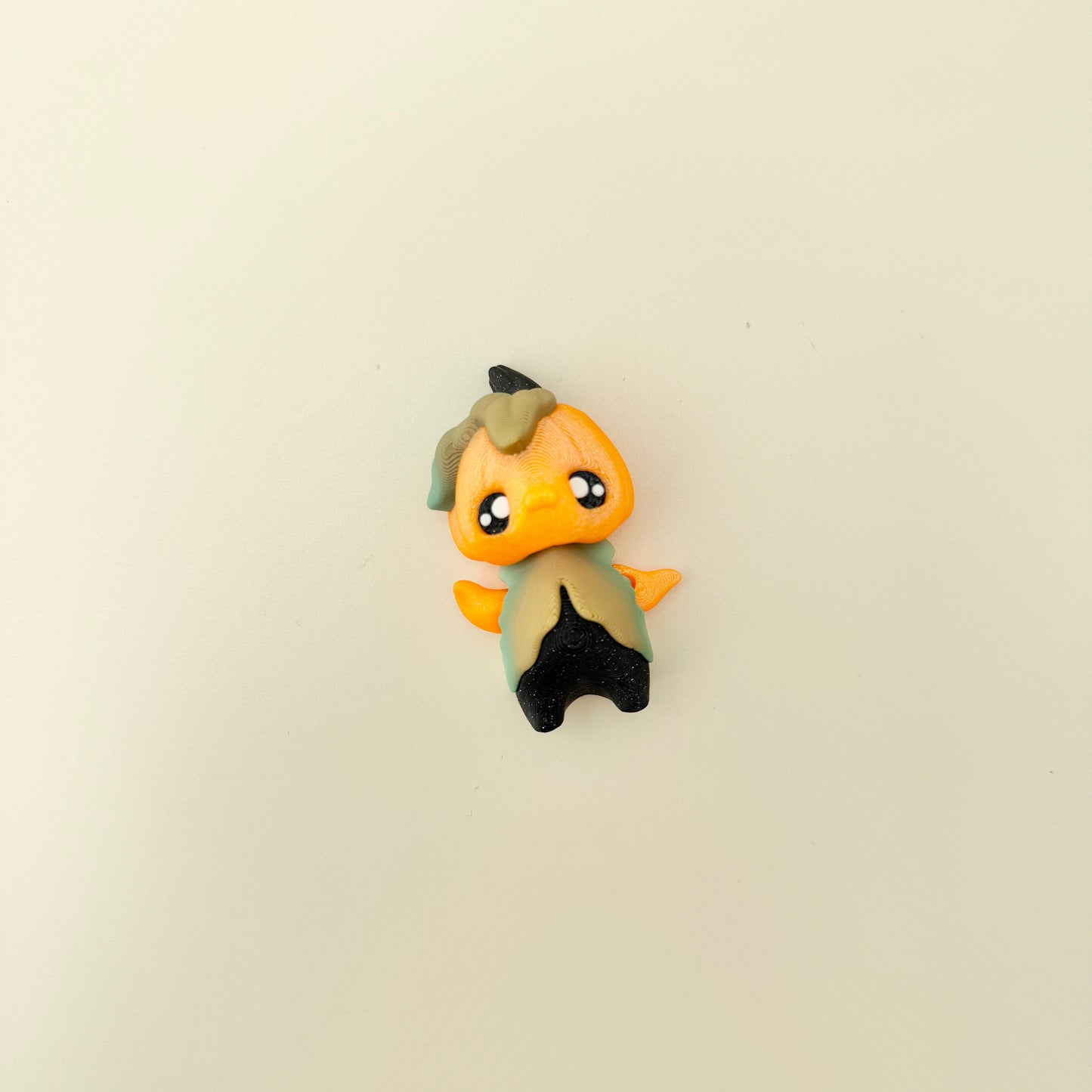 Compact pixie ornament with tactile surfaces suitable for grounding and focus.