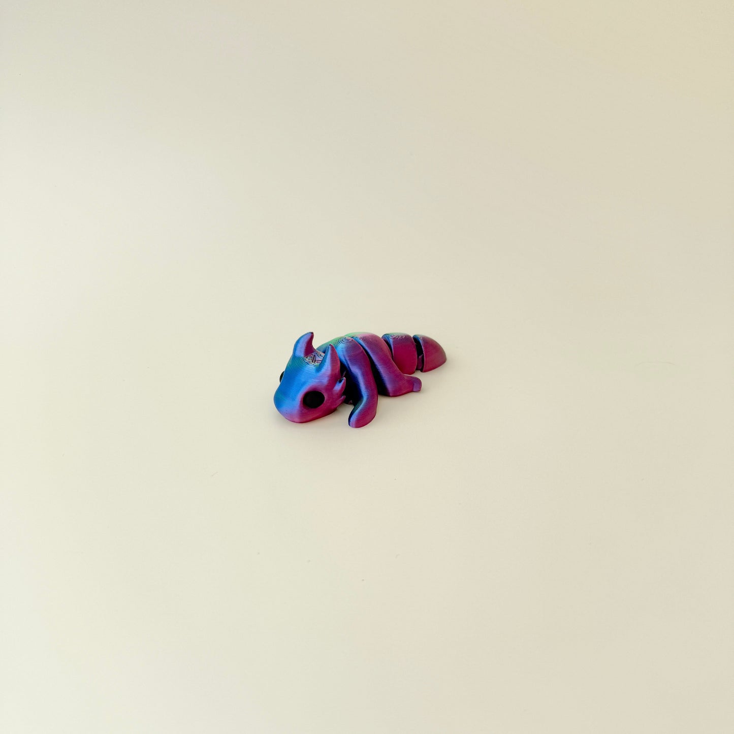 Pocket-sized dragon fidget with flexible joints and smooth texture.