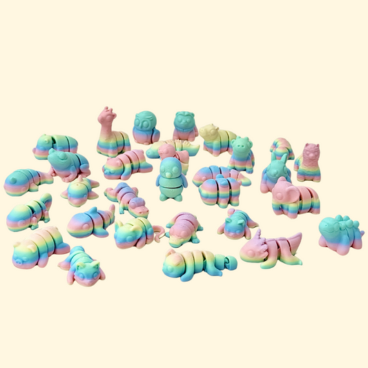 Small rainbow-coloured fidget toys with flexible, articulated bodies designed for sensory play.